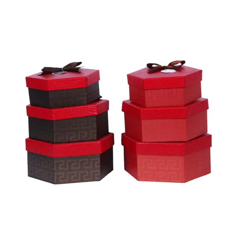 Caja rígida de embalaje de regalo en forma de hexágono con cinta.